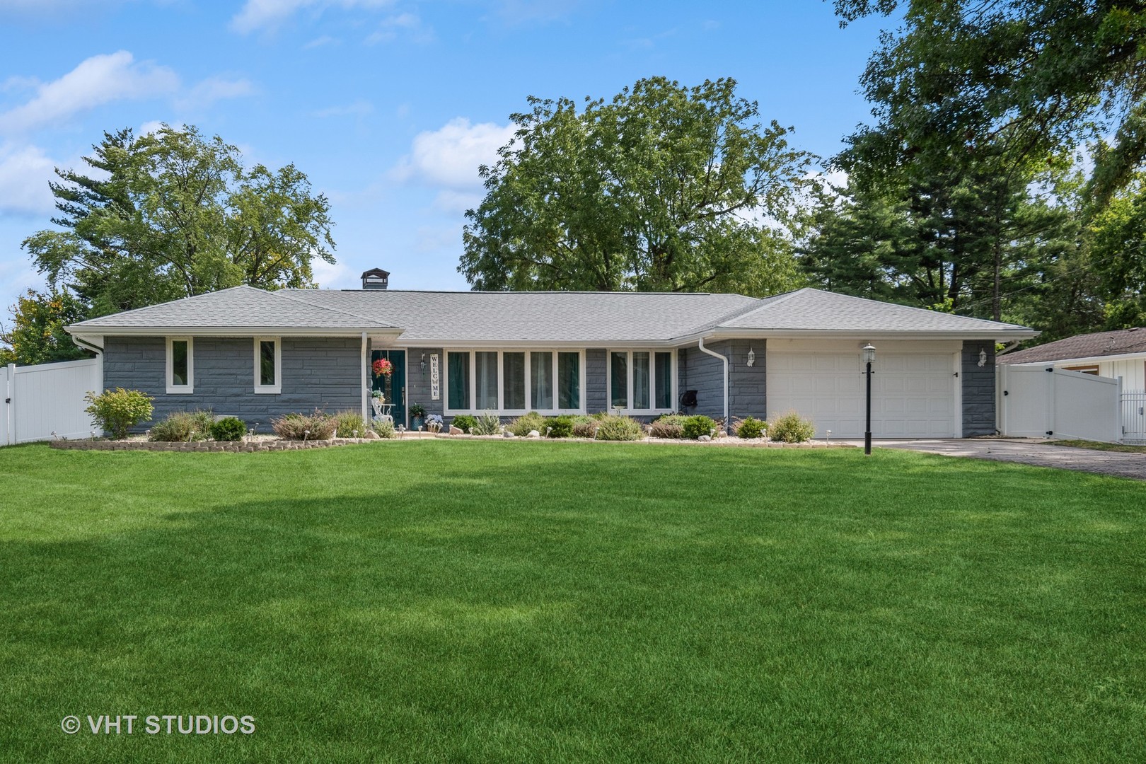 14107 Naperville Road Plainfield, IL 60544 - Photo 1 of 49 a front view of a house with a garden