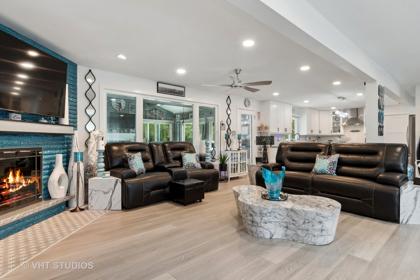 14107 Naperville Road Plainfield, IL 60544 - Photo 13 of 49 a living room with furniture a flat screen tv and a fireplace