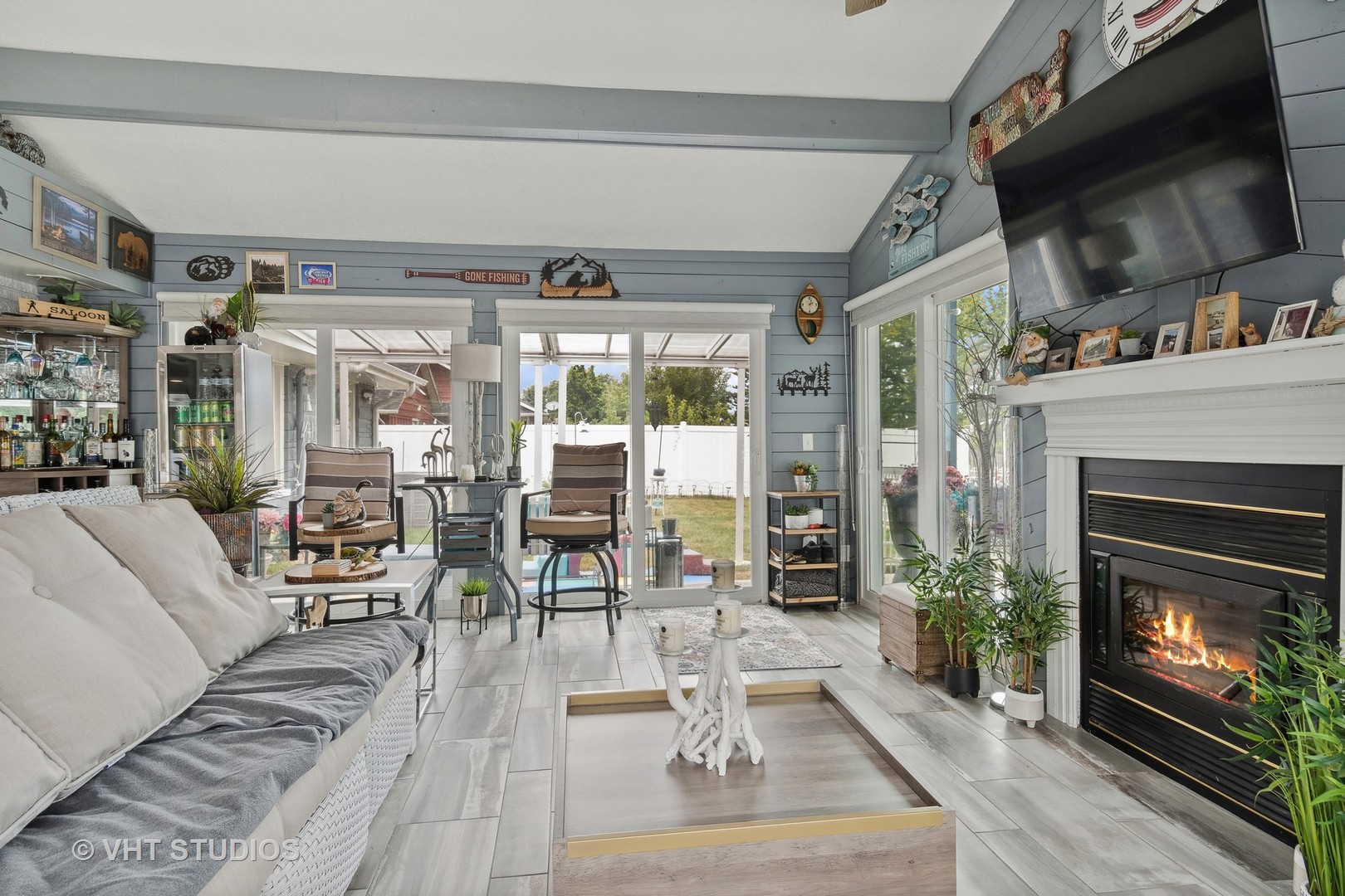 14107 Naperville Road Plainfield, IL 60544 - Photo 15 of 49 a living room with furniture a flat screen tv and a fireplace