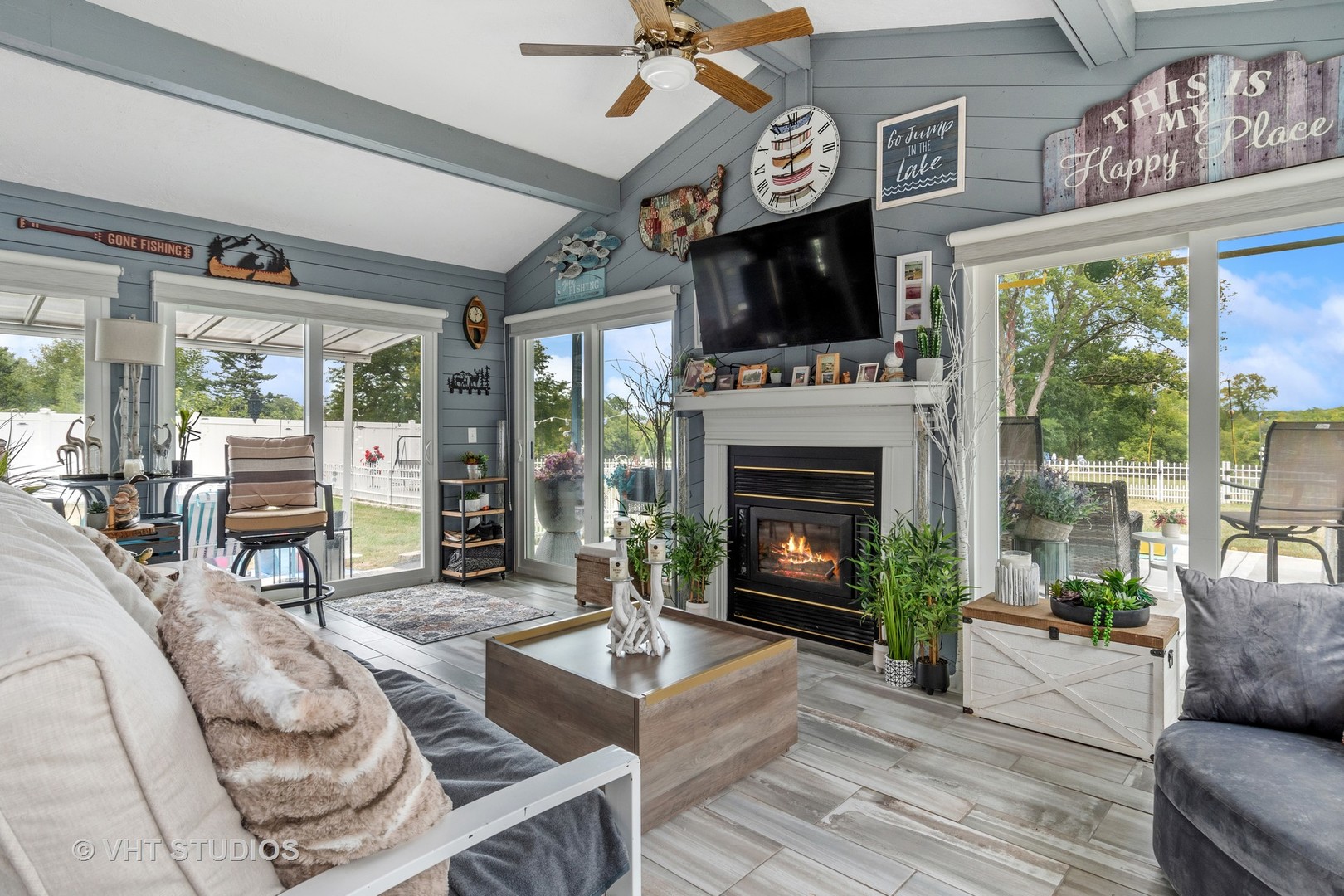 14107 Naperville Road Plainfield, IL 60544 - Photo 16 of 49 a living room with furniture a fireplace a flat screen tv and a large window