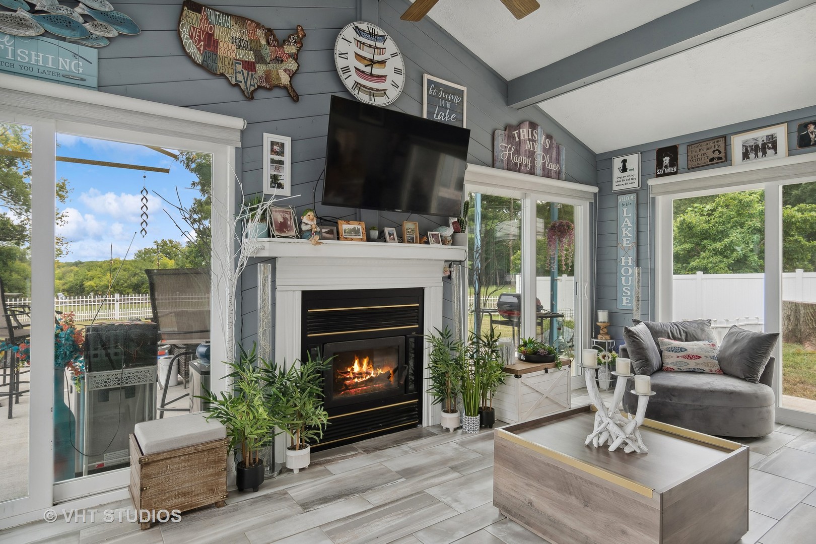 14107 Naperville Road Plainfield, IL 60544 - Photo 17 of 49 a living room with furniture a flat screen tv and a fireplace
