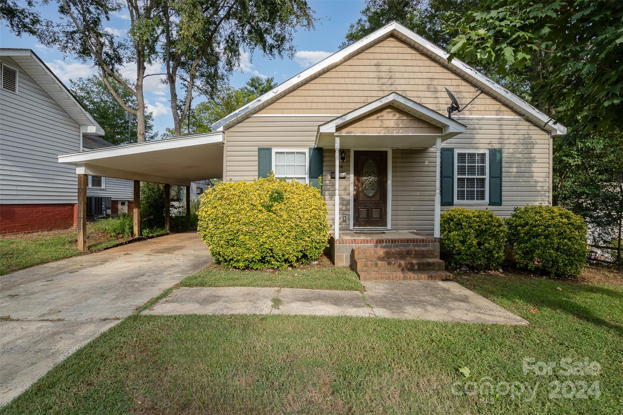 484 Cook Street Northwest Concord, NC 28025 - Photo 1 of 32 a view of a house with a yard and potted plants