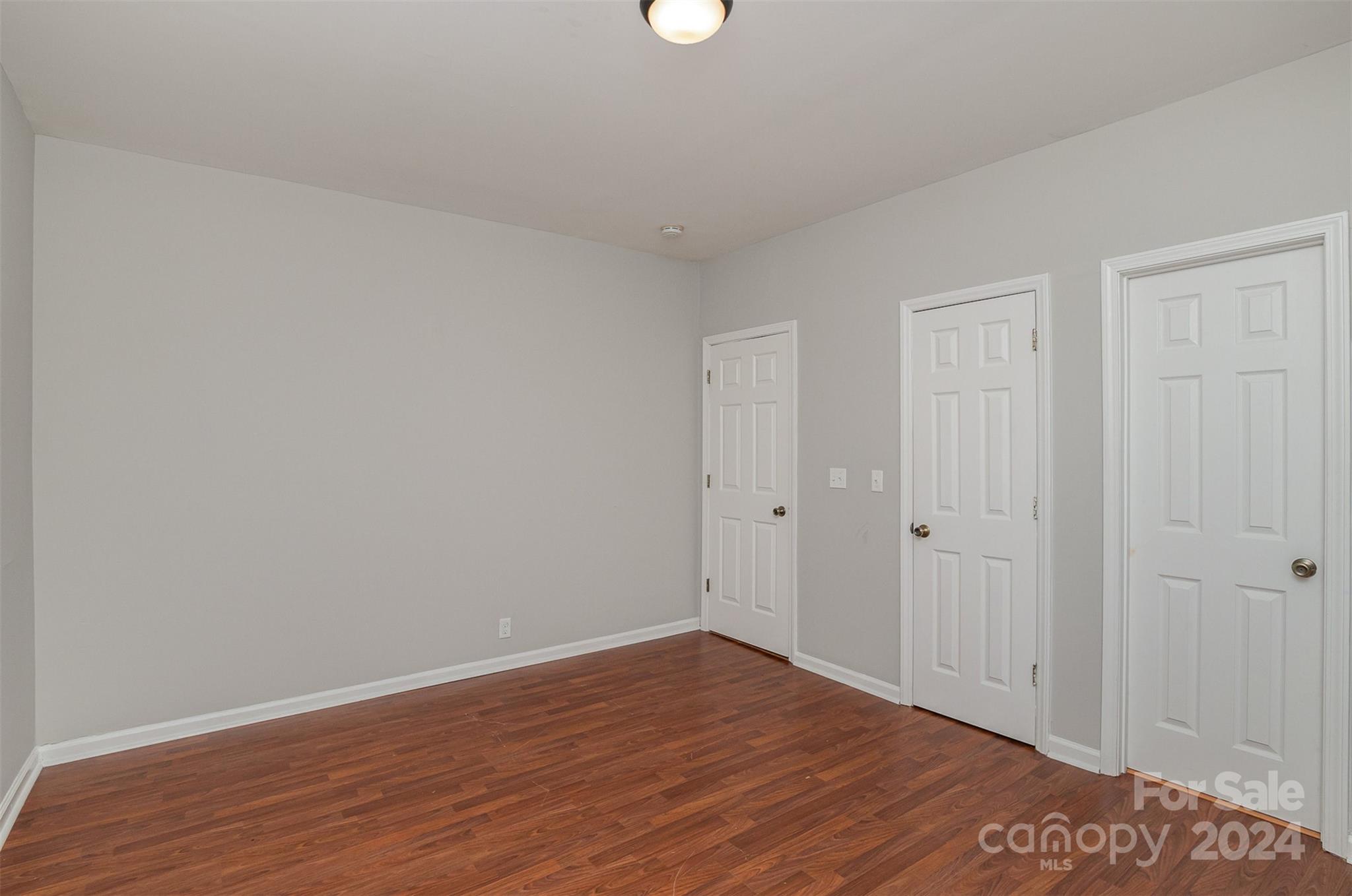 484 Cook Street Northwest Concord, NC 28025 - Photo 12 of 32 a view of an empty room with wooden floor