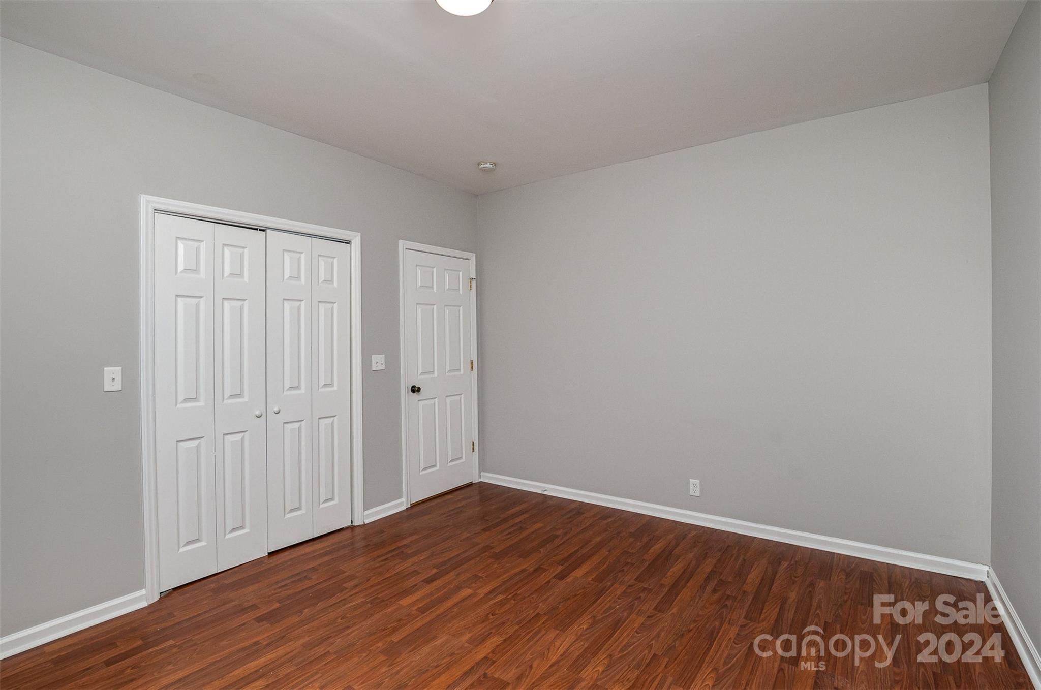484 Cook Street Northwest Concord, NC 28025 - Photo 14 of 32 a view of an empty room with wooden floor