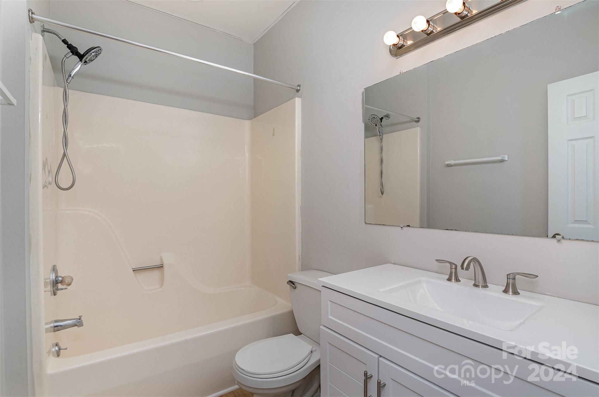 484 Cook Street Northwest Concord, NC 28025 - Photo 17 of 32 a bathroom with a granite countertop sink toilet and shower