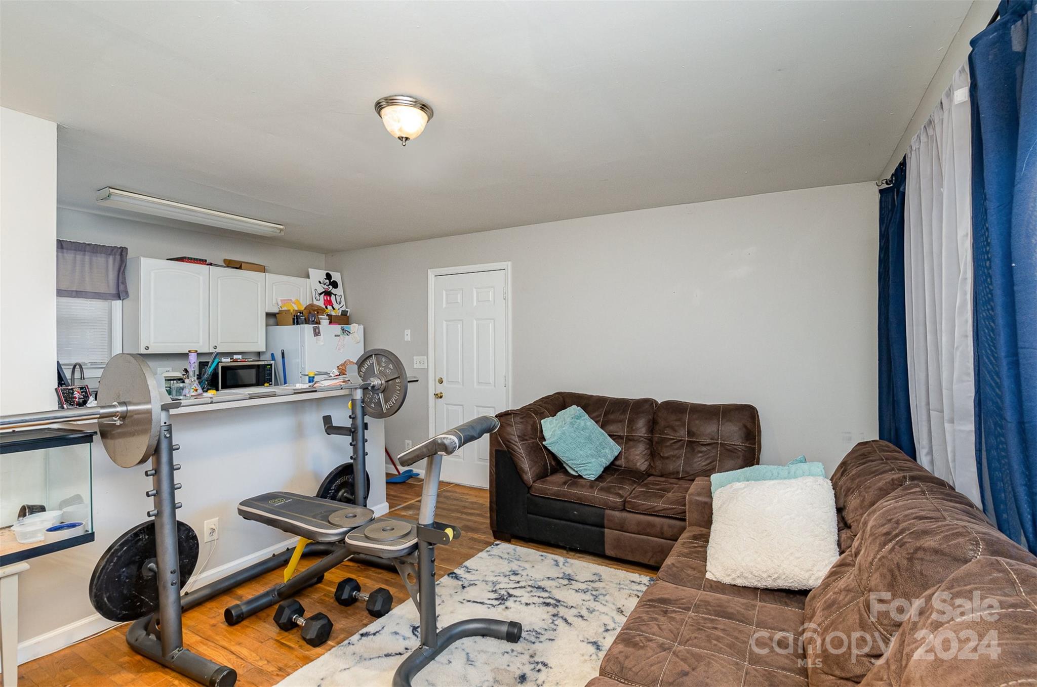 484 Cook Street Northwest Concord, NC 28025 - Photo 23 of 32 a living room with furniture a rug and white walls