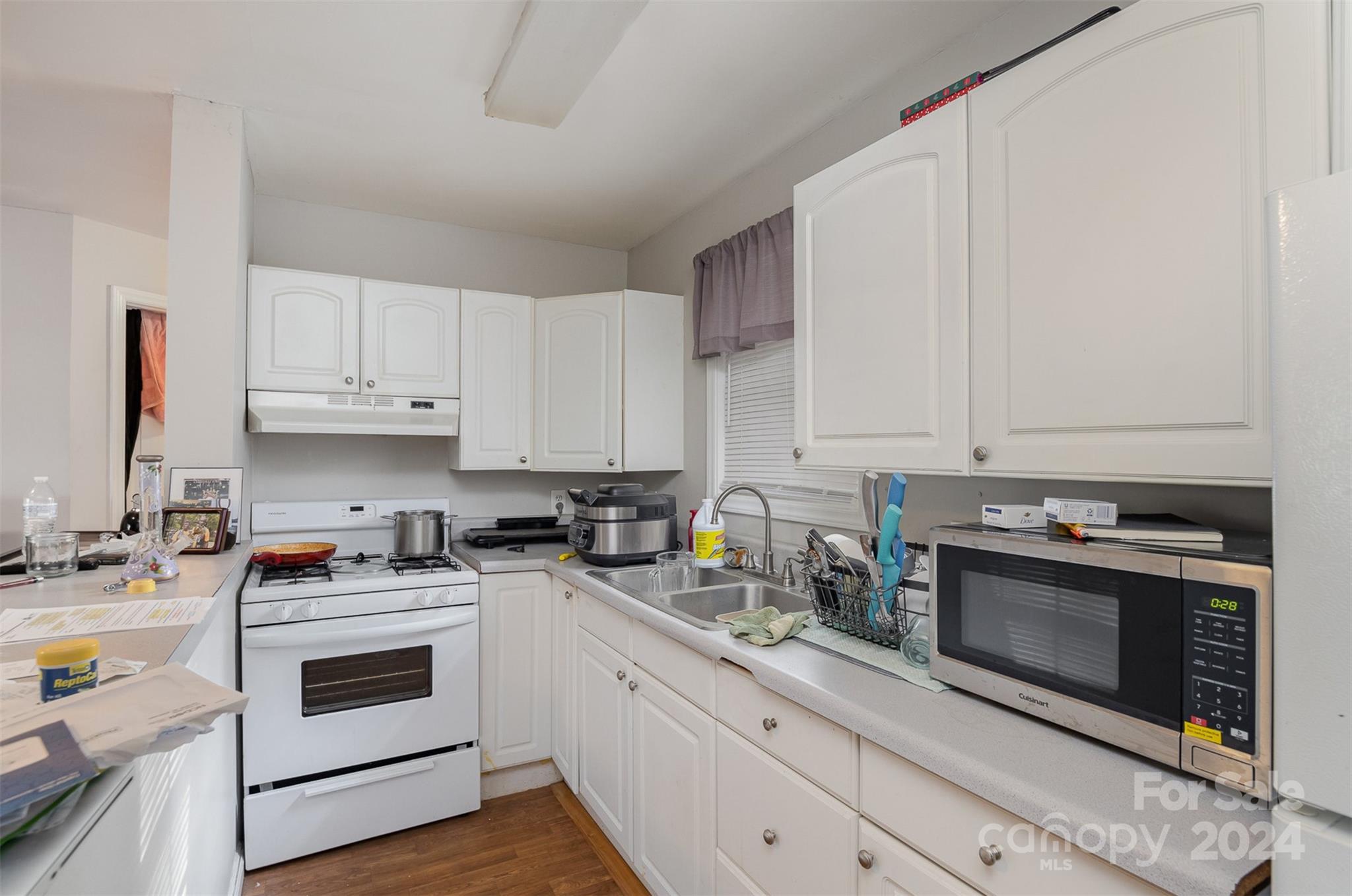484 Cook Street Northwest Concord, NC 28025 - Photo 25 of 32 a kitchen with a stove and a sink