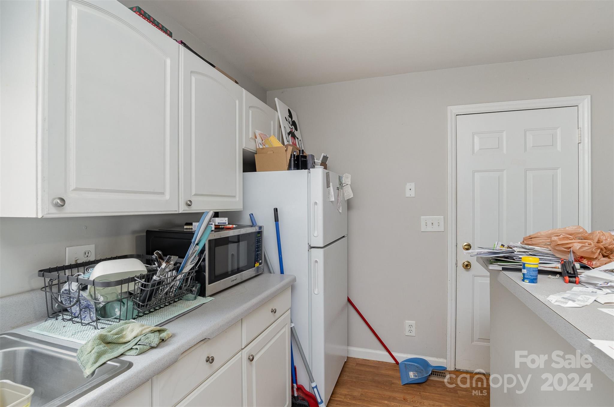 484 Cook Street Northwest Concord, NC 28025 - Photo 26 of 32 a kitchen with a refrigerator sink and cabinets