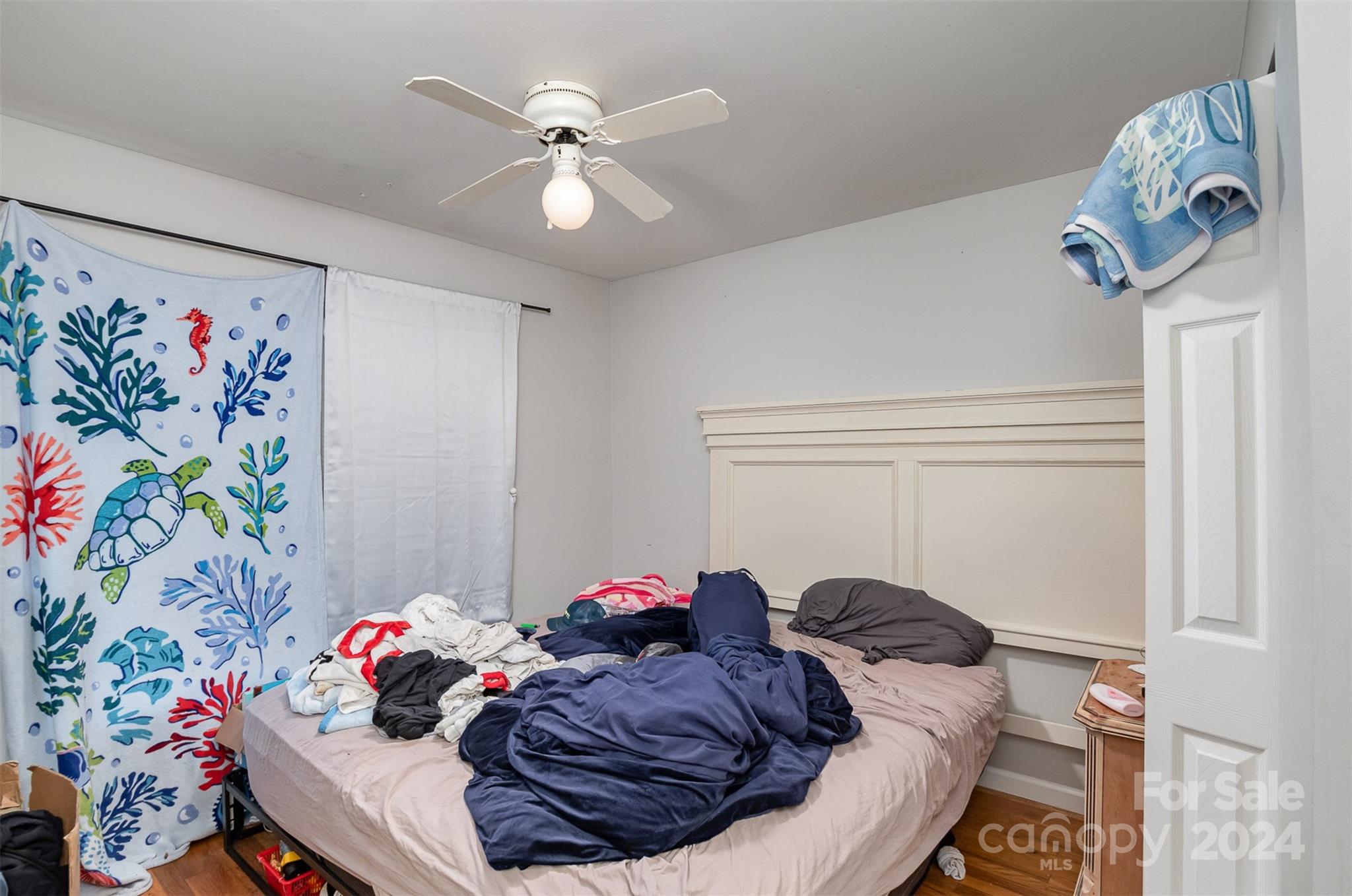 484 Cook Street Northwest Concord, NC 28025 - Photo 27 of 32 a bed room with a bed and a chandelier