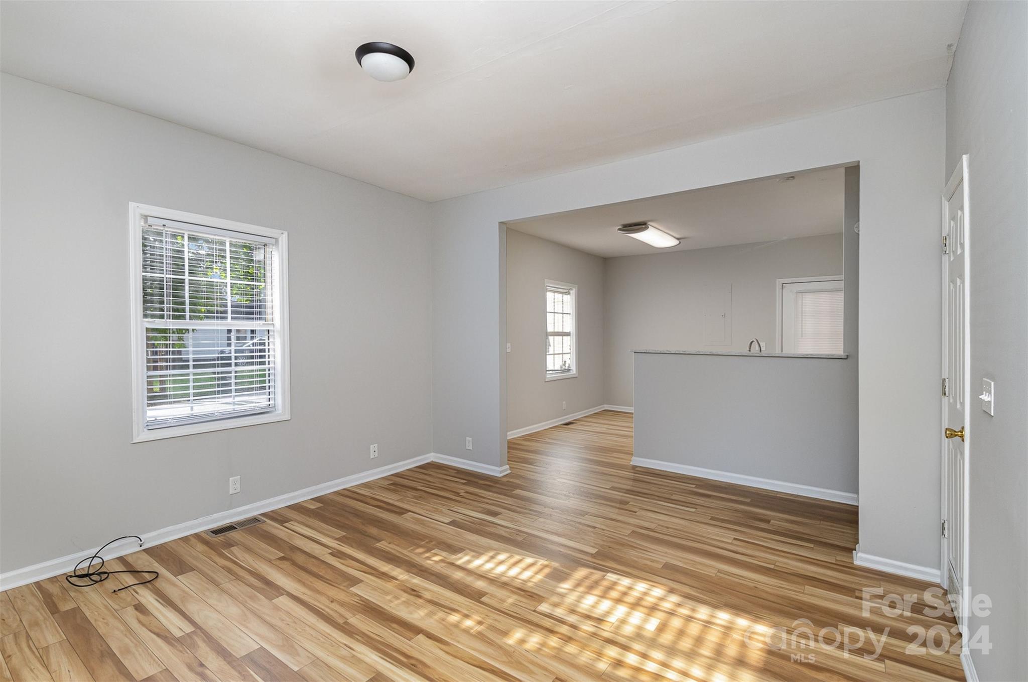 484 Cook Street Northwest Concord, NC 28025 - Photo 3 of 32 a view of empty room with wooden floor and fan