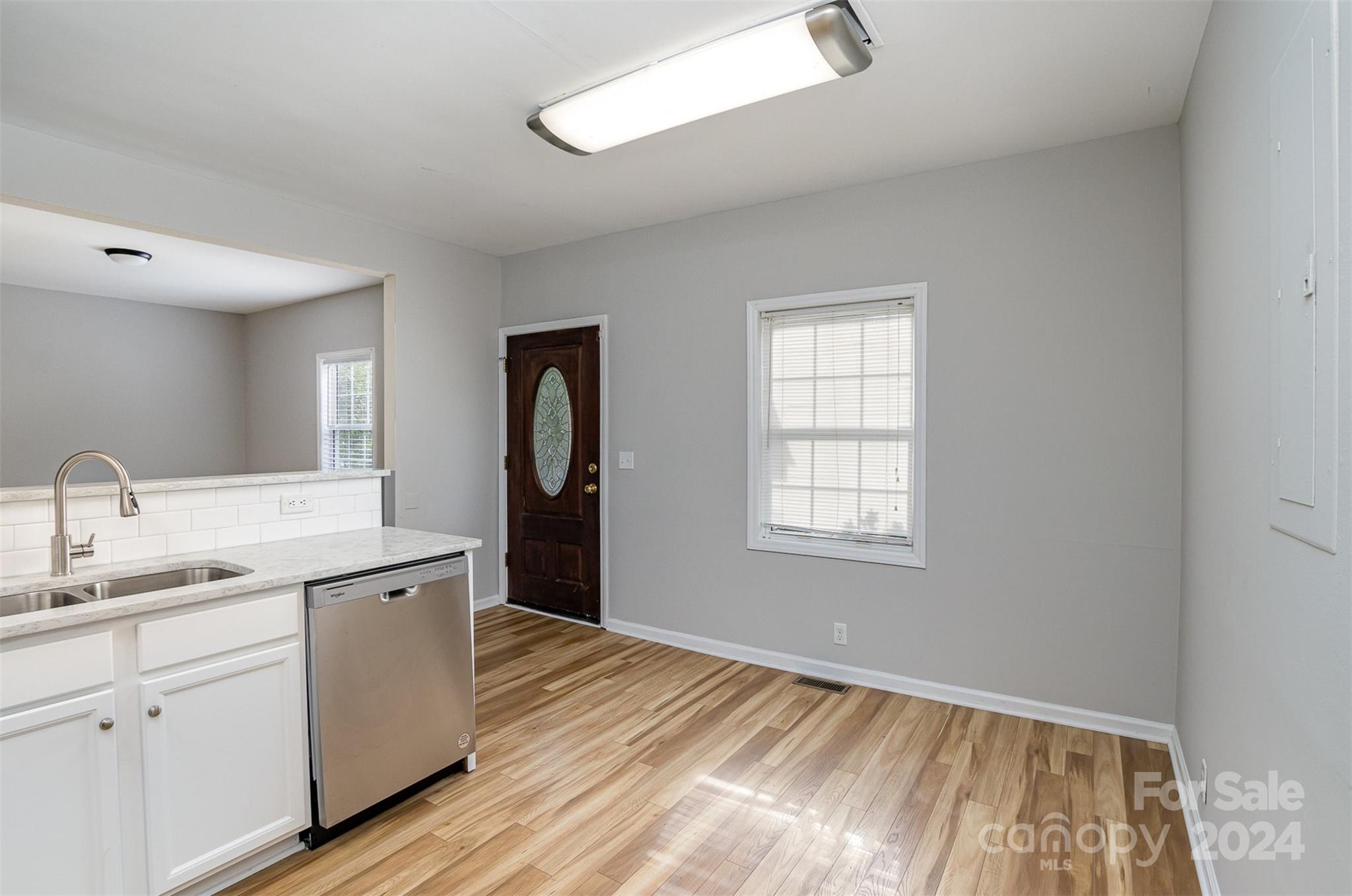 484 Cook Street Northwest Concord, NC 28025 - Photo 6 of 32 a view of a kitchen with sink and dishwasher with wooden floor
