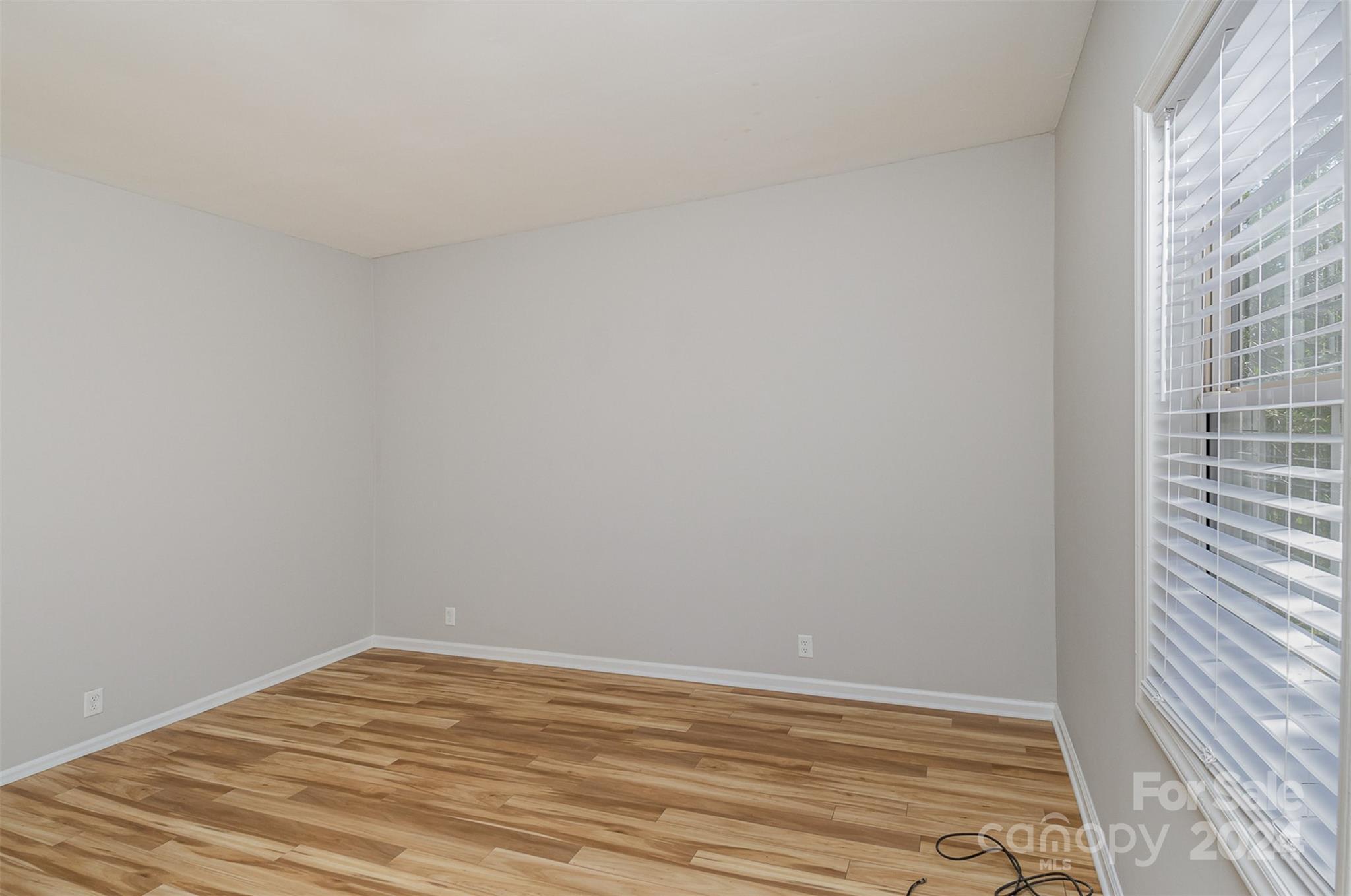 484 Cook Street Northwest Concord, NC 28025 - Photo 8 of 32 a view of empty room with wooden floor and fan