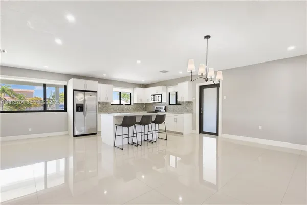 a view of a kitchen with furniture and wooden floor
