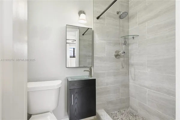 a bathroom with a toilet and a shower