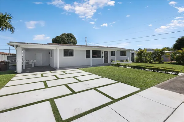 a view of a house with a backyard