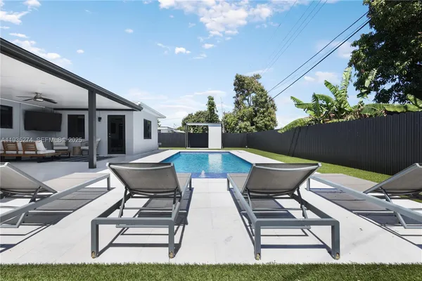 a view of a patio with table and chairs and potted plants