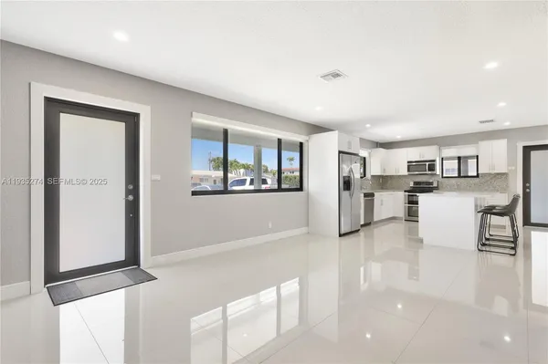 a view of kitchen with furniture and wooden floor