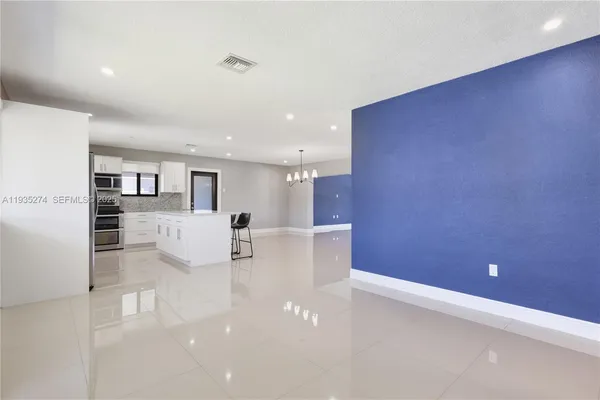 a view of kitchen with furniture and refrigerator