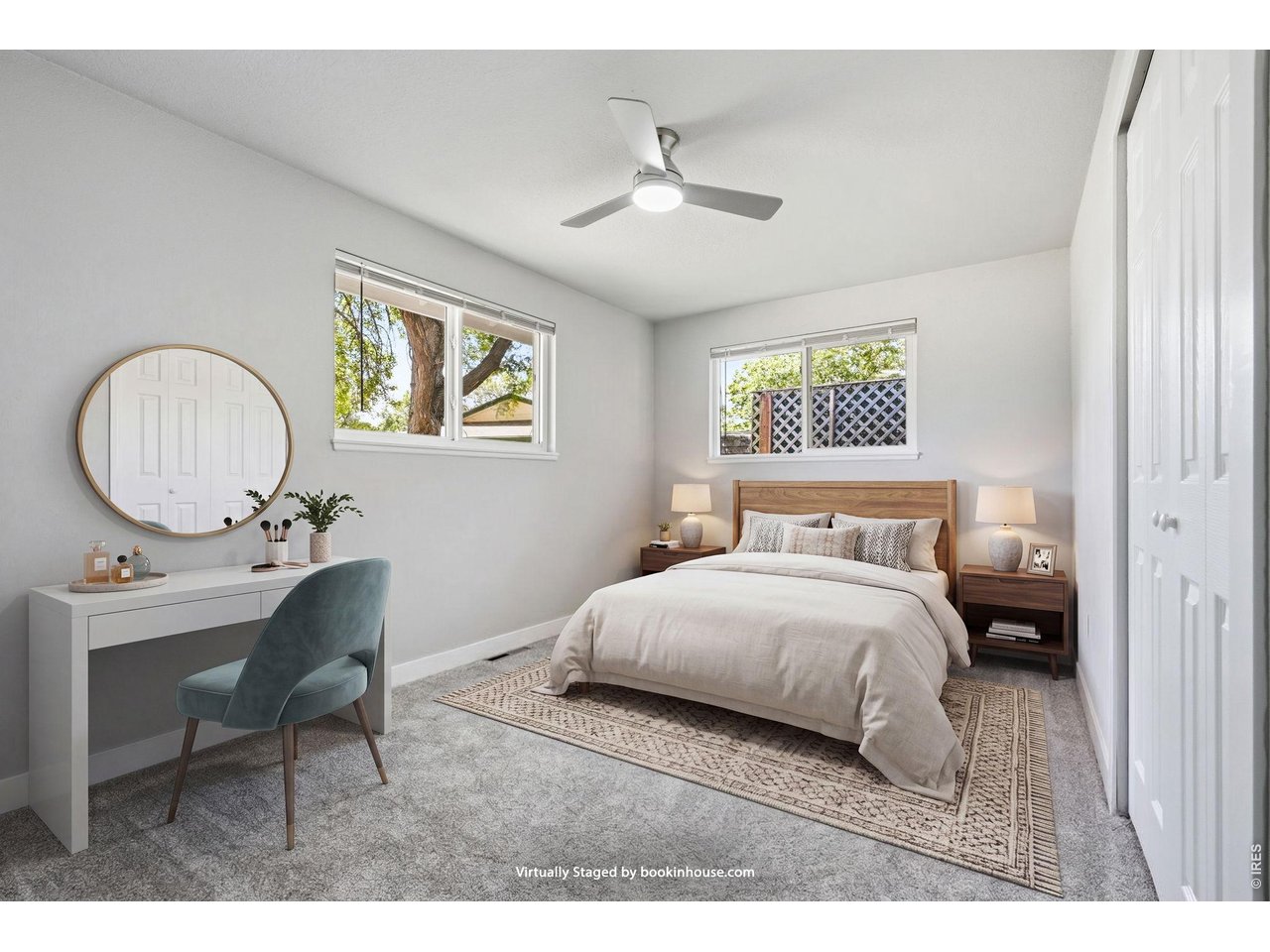 1035 6th Street Berthoud, CO 80513 - Photo 23 of 37 a bedroom with a bed a mirror and a table