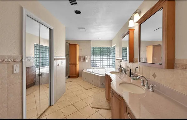 a bathroom with a granite countertop sink mirror and double