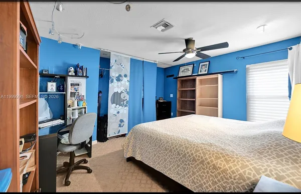 a bedroom with a bed and a desk