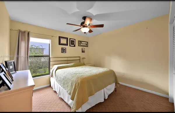 a bedroom with a large bed couch and a window
