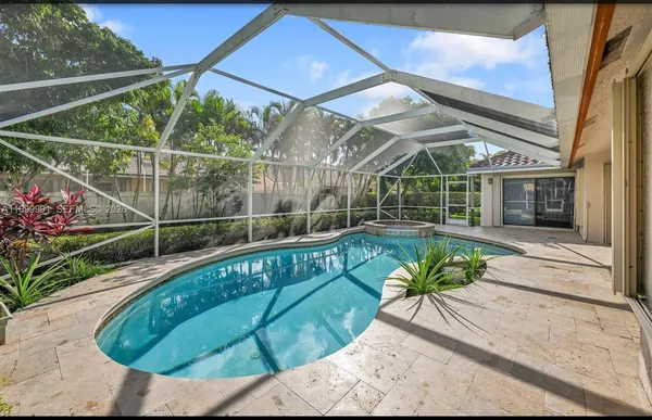 a view of a house with a wooden fence