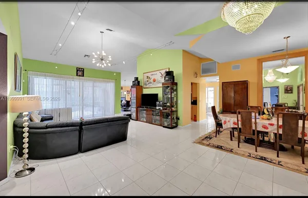 a view of a livingroom with furniture and a flat screen tv
