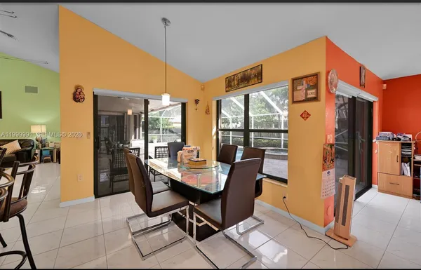 a dining room with furniture a chandelier and fireplace