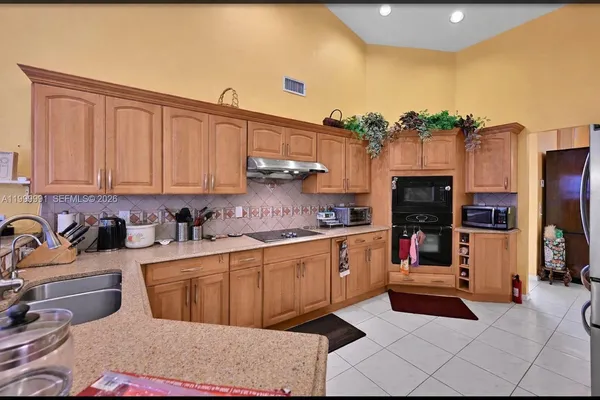 a kitchen with stainless steel appliances granite countertop a sink and cabinets