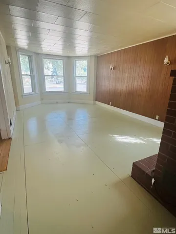 a view of an empty room with windows