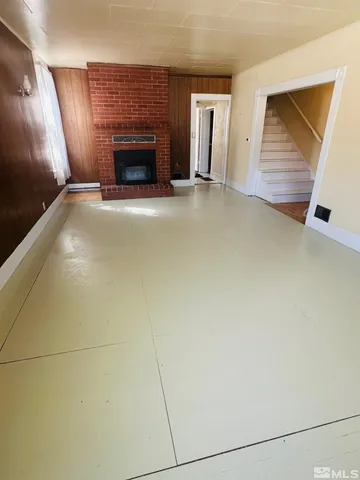 a view of an empty room with a fireplace