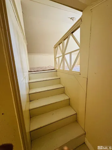 a view of a patio with table and chairs with wooden floor and fence