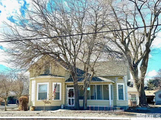 front view of a building with a trees