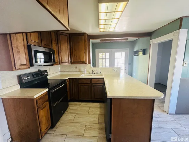 a kitchen with a sink appliances and cabinets