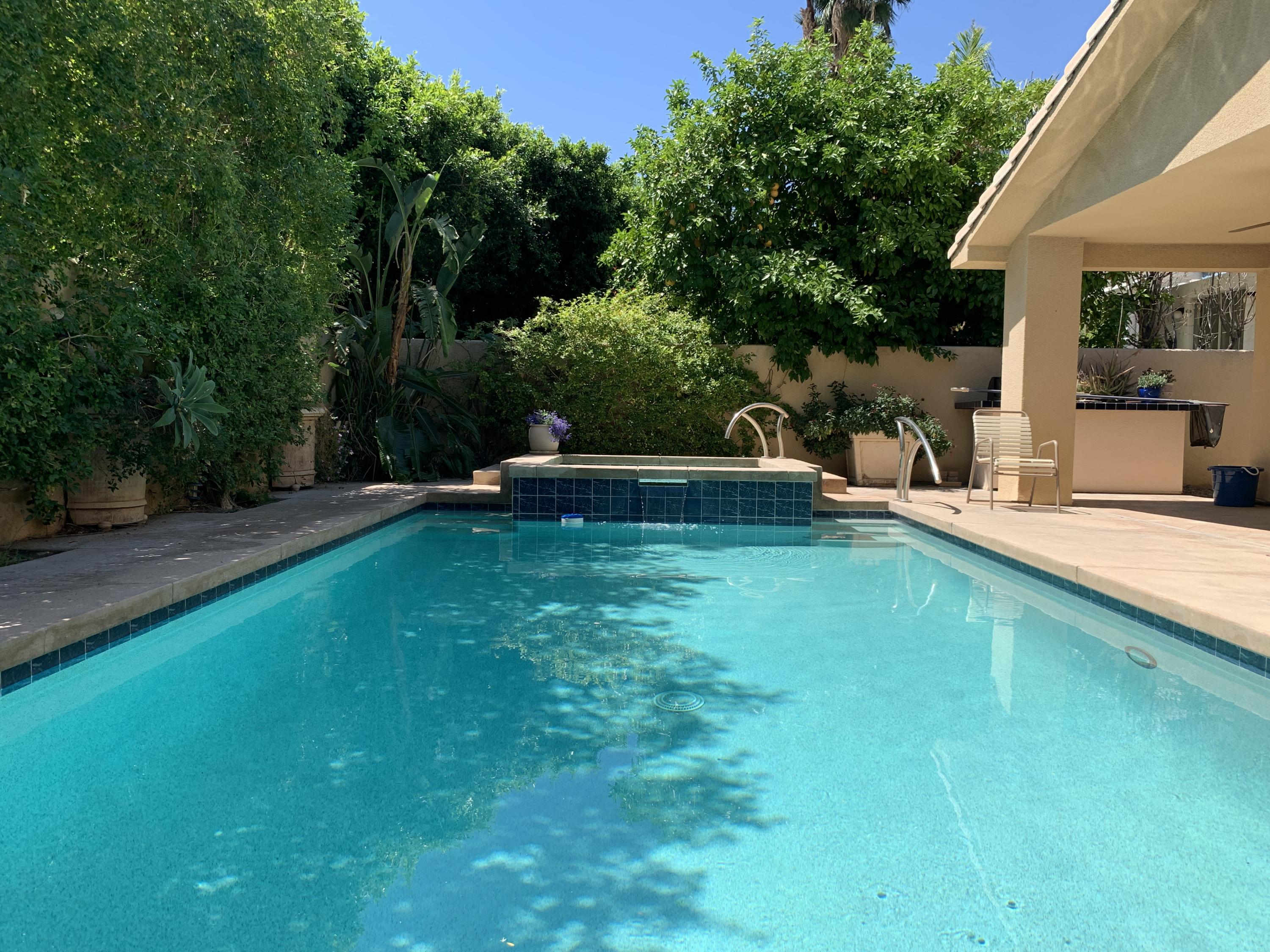 68921 Risueno Road Cathedral City, CA 92234 - Photo 11 of 20 a view of a house with a backyard patio and swimming pool