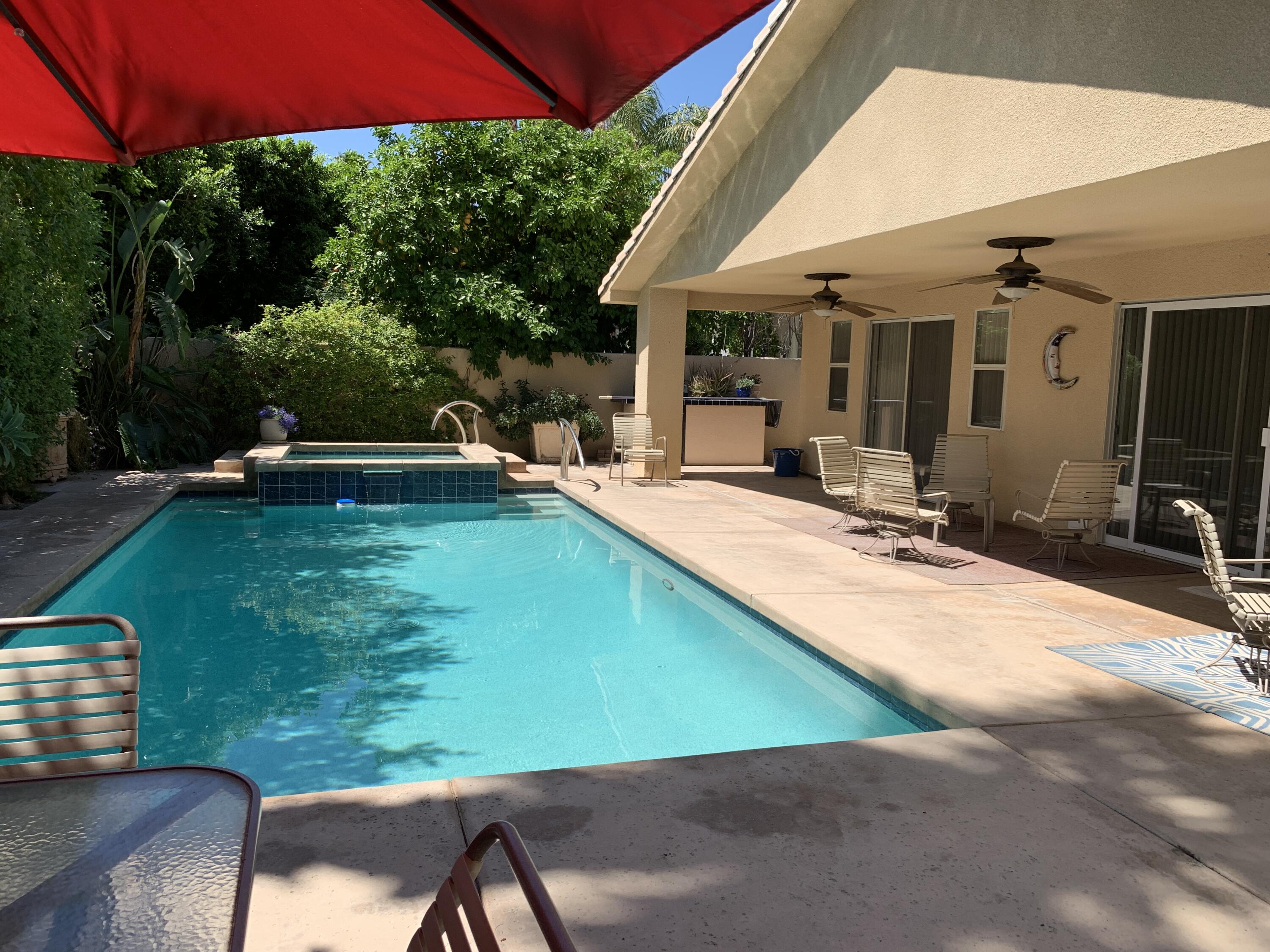 68921 Risueno Road Cathedral City, CA 92234 - Photo 12 of 20 a view of a patio with table and chairs under an umbrella