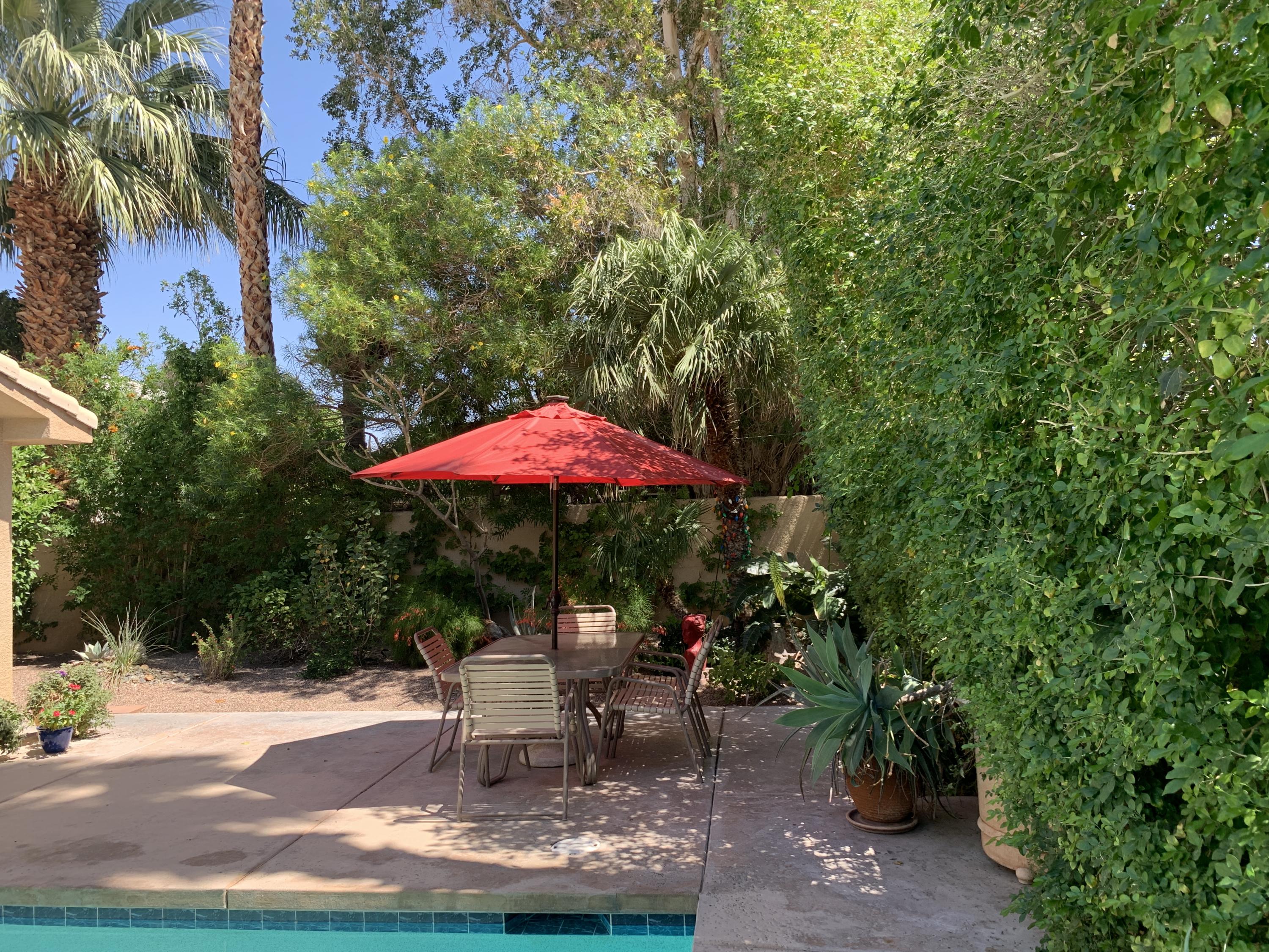 68921 Risueno Road Cathedral City, CA 92234 - Photo 13 of 20 a patio with a table and chairs under an umbrella