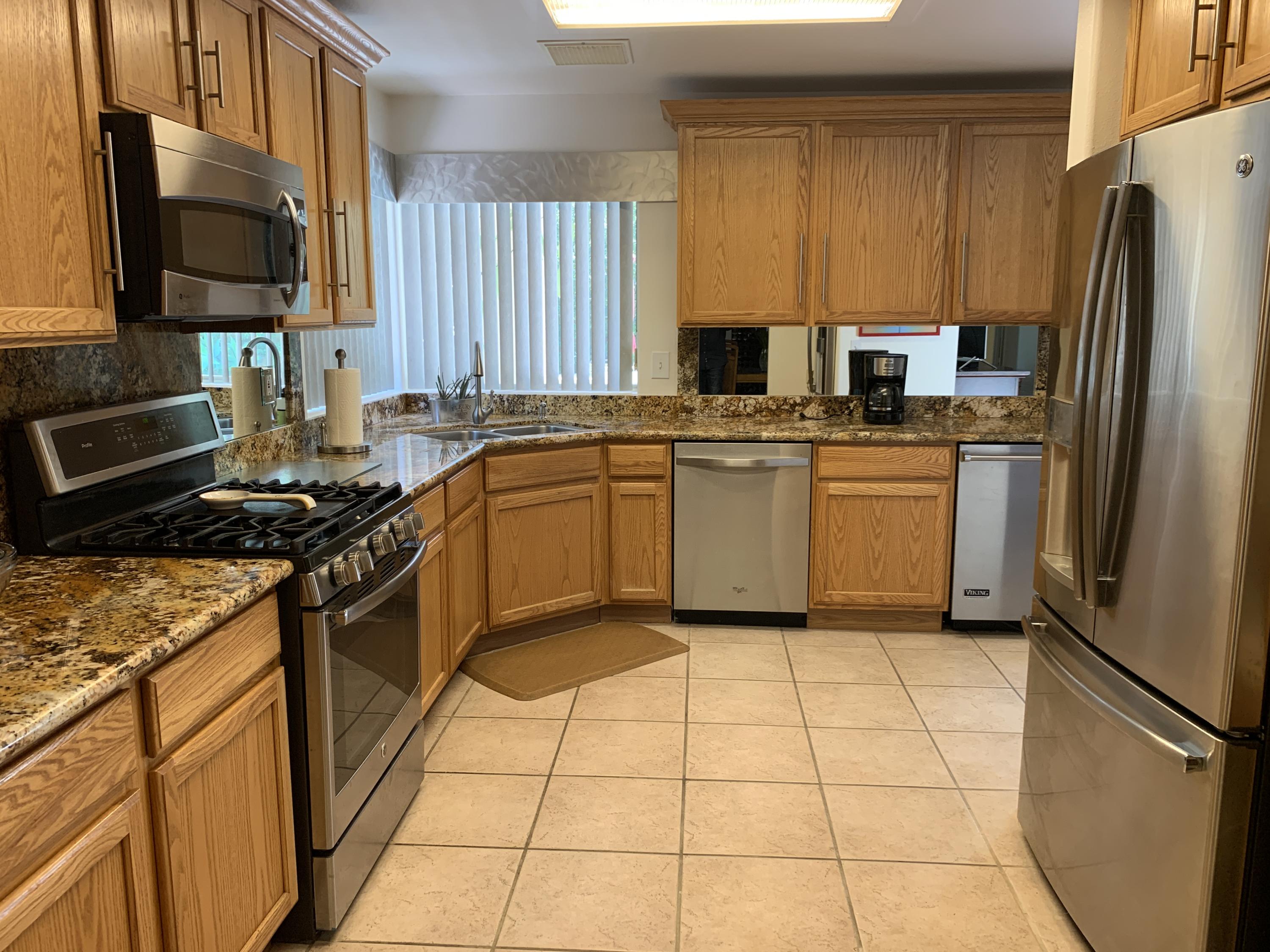 68921 Risueno Road Cathedral City, CA 92234 - Photo 3 of 20 a kitchen with stainless steel appliances granite countertop a refrigerator sink and stove