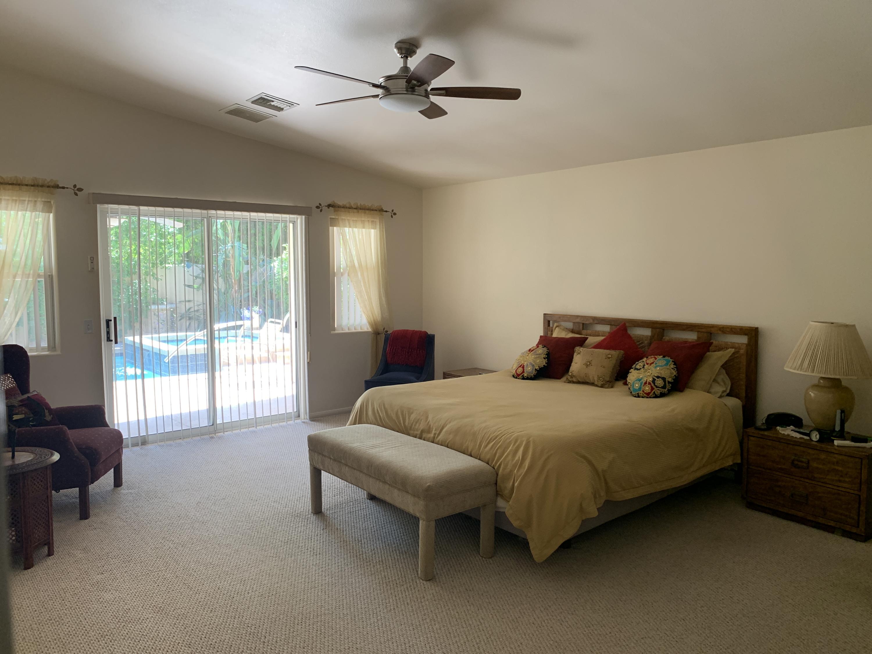 68921 Risueno Road Cathedral City, CA 92234 - Photo 7 of 20 a bedroom with a bed and a couch