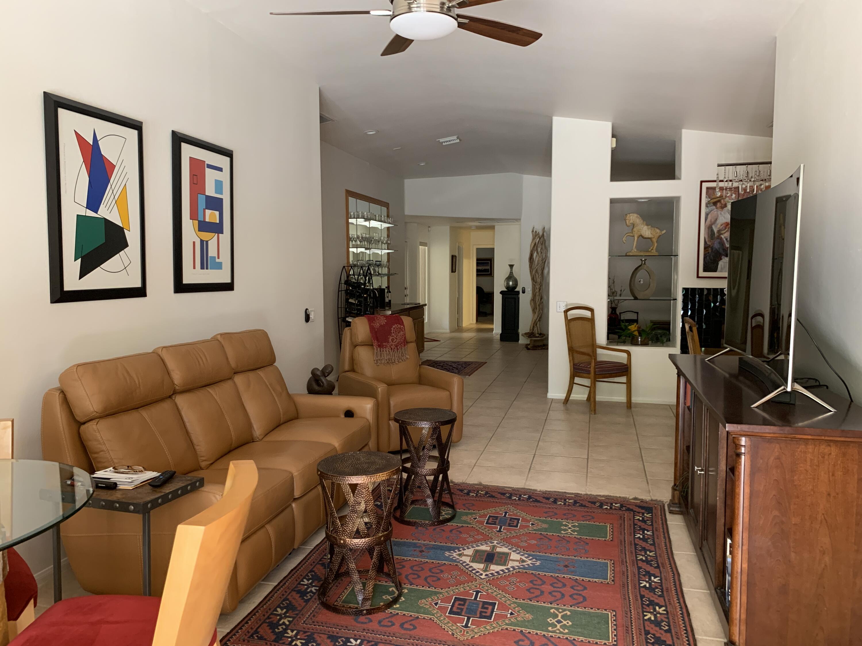 68921 Risueno Road Cathedral City, CA 92234 - Photo 9 of 20 a living room with furniture a flat screen tv and kitchen view