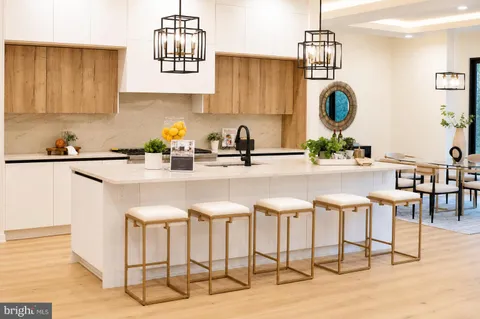 a dining room with furniture a chandelier and wooden floor