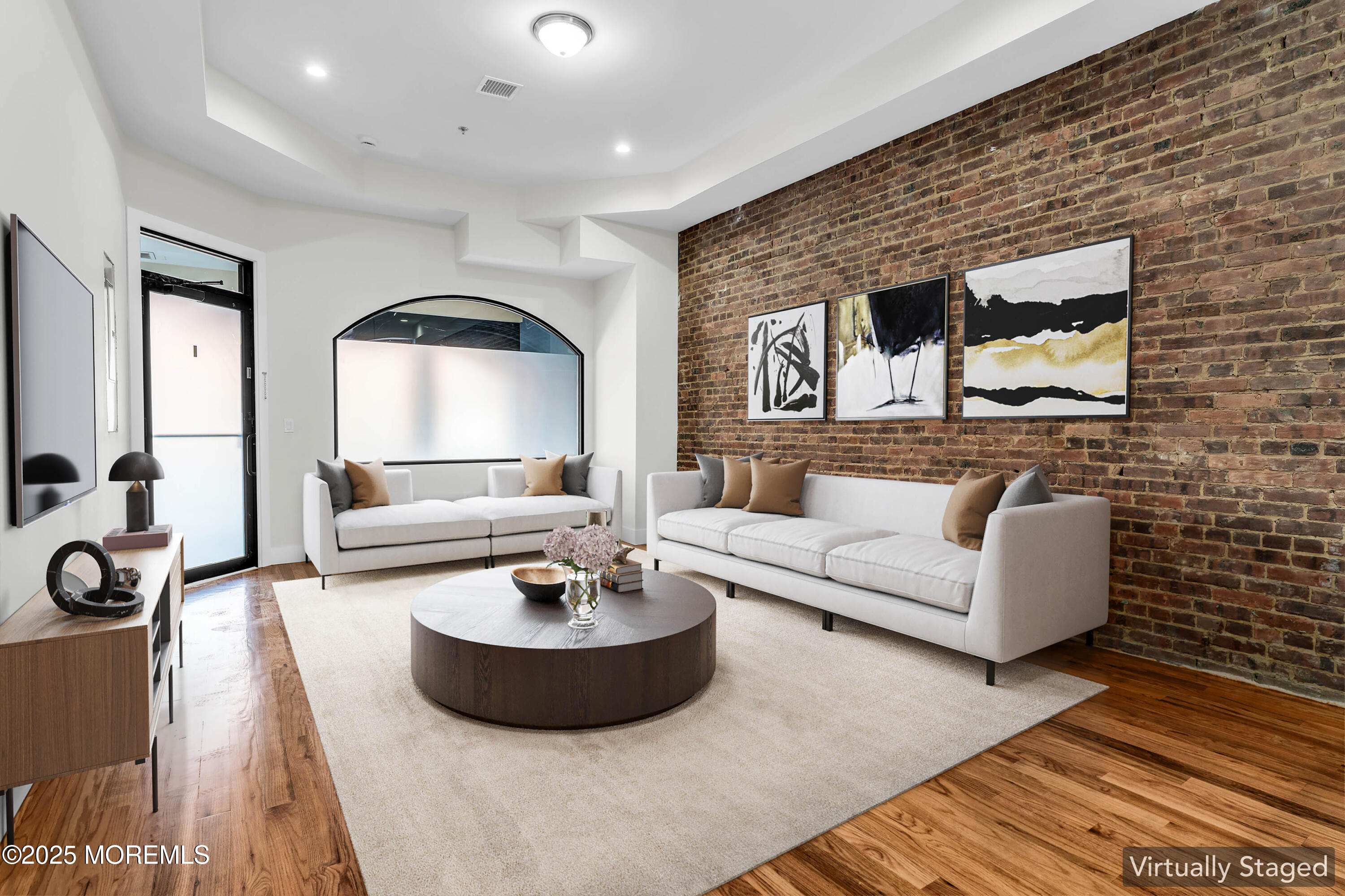 a living room with furniture and a wooden floor