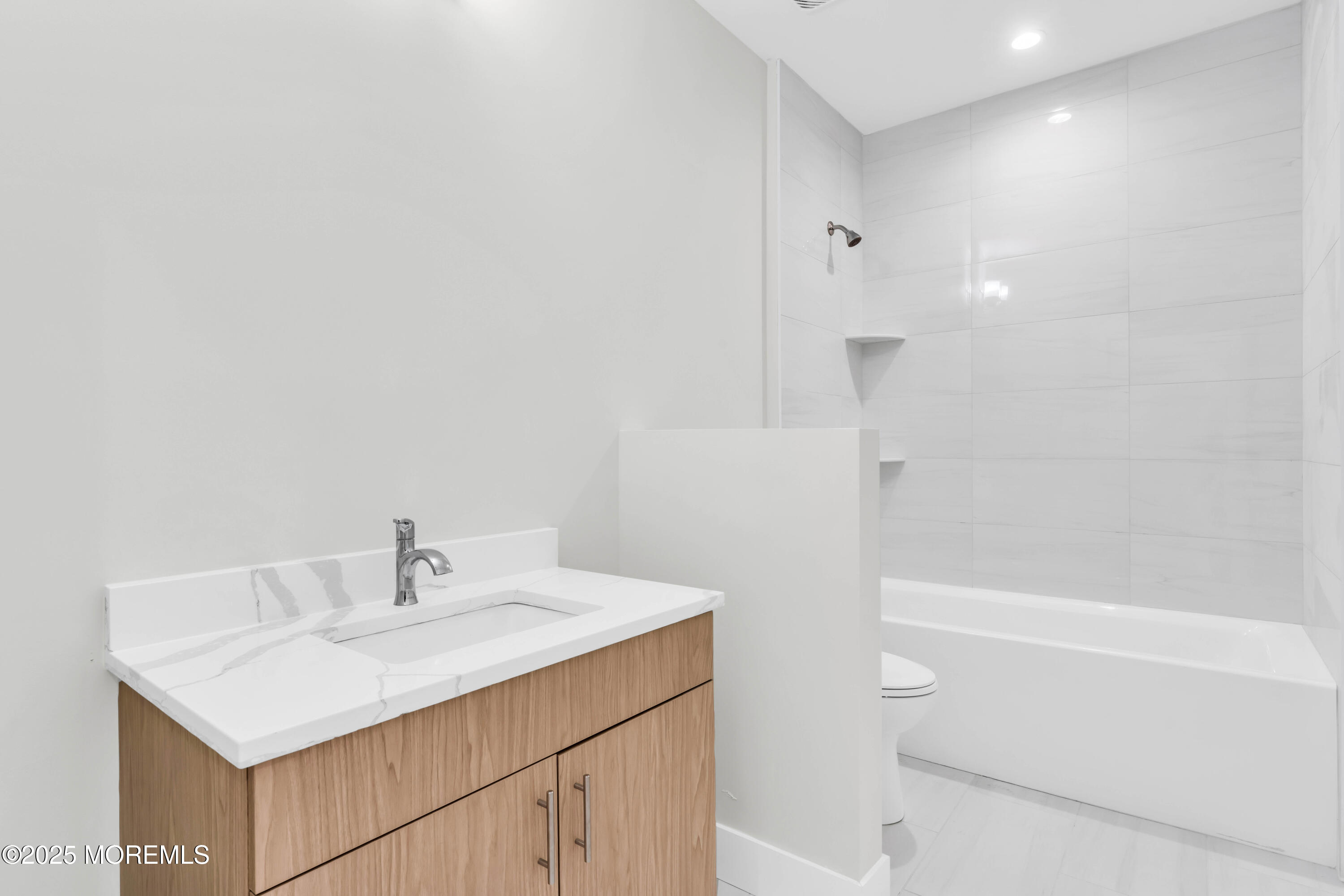 7 Broad Street, Unit 1 Red Bank, NJ 07701 - Photo 16 of 28 a bathroom with a sink a toilet and shower