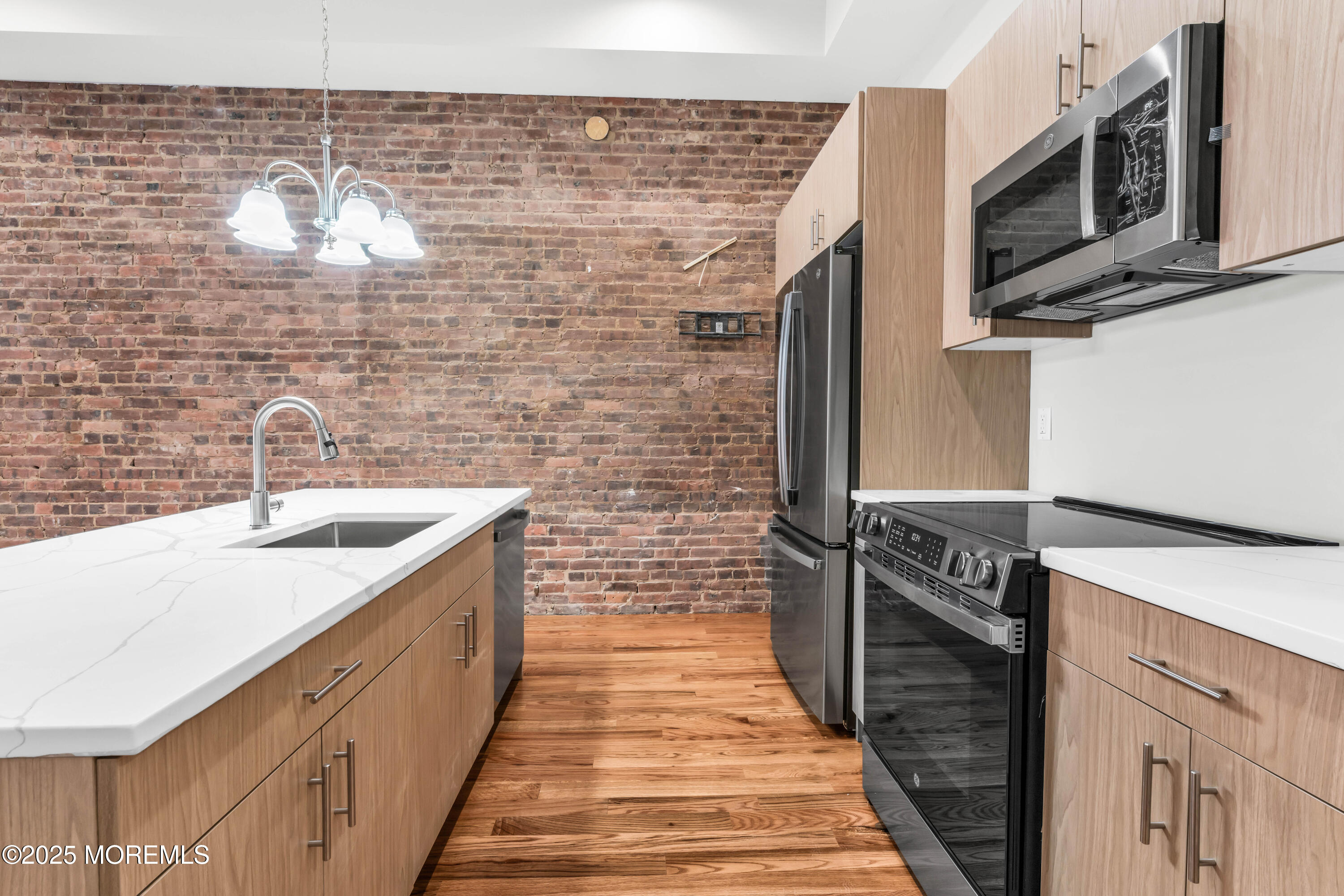 7 Broad Street, Unit 1 Red Bank, NJ 07701 - Photo 8 of 28 a kitchen with stainless steel appliances a sink stove top oven and cabinets
