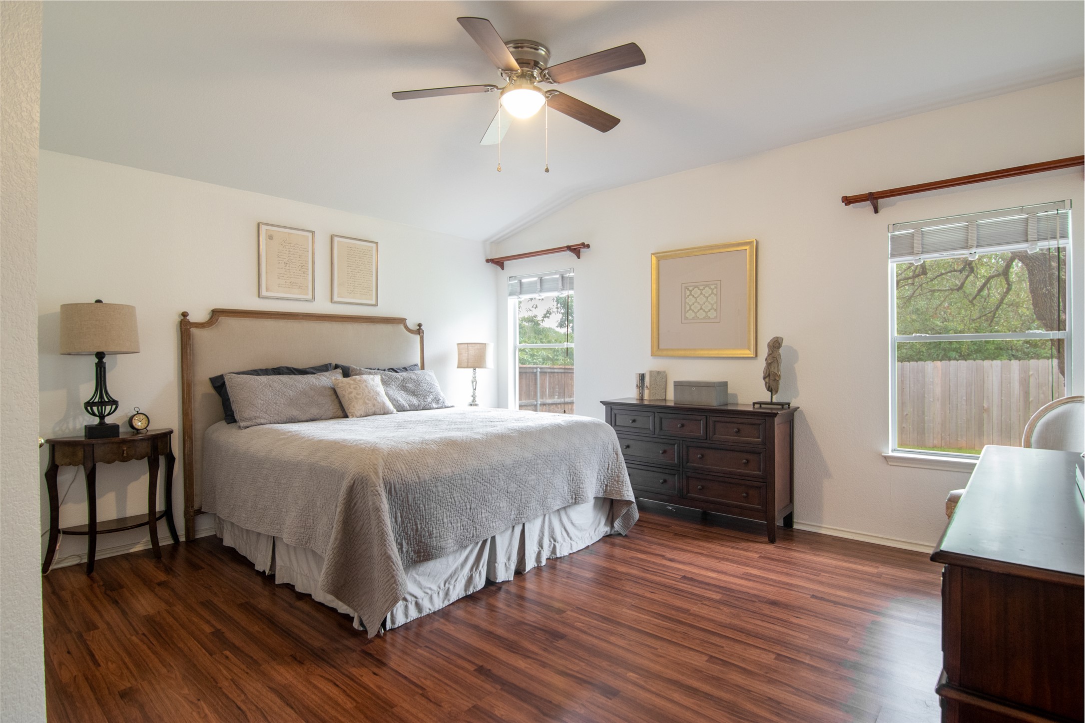8901 Copano Drive Austin, TX 78749 - Photo 17 of 29 Spacious primary bedroom featuring hard flooring, abundant natural light, and a ceiling fan for added comfort.