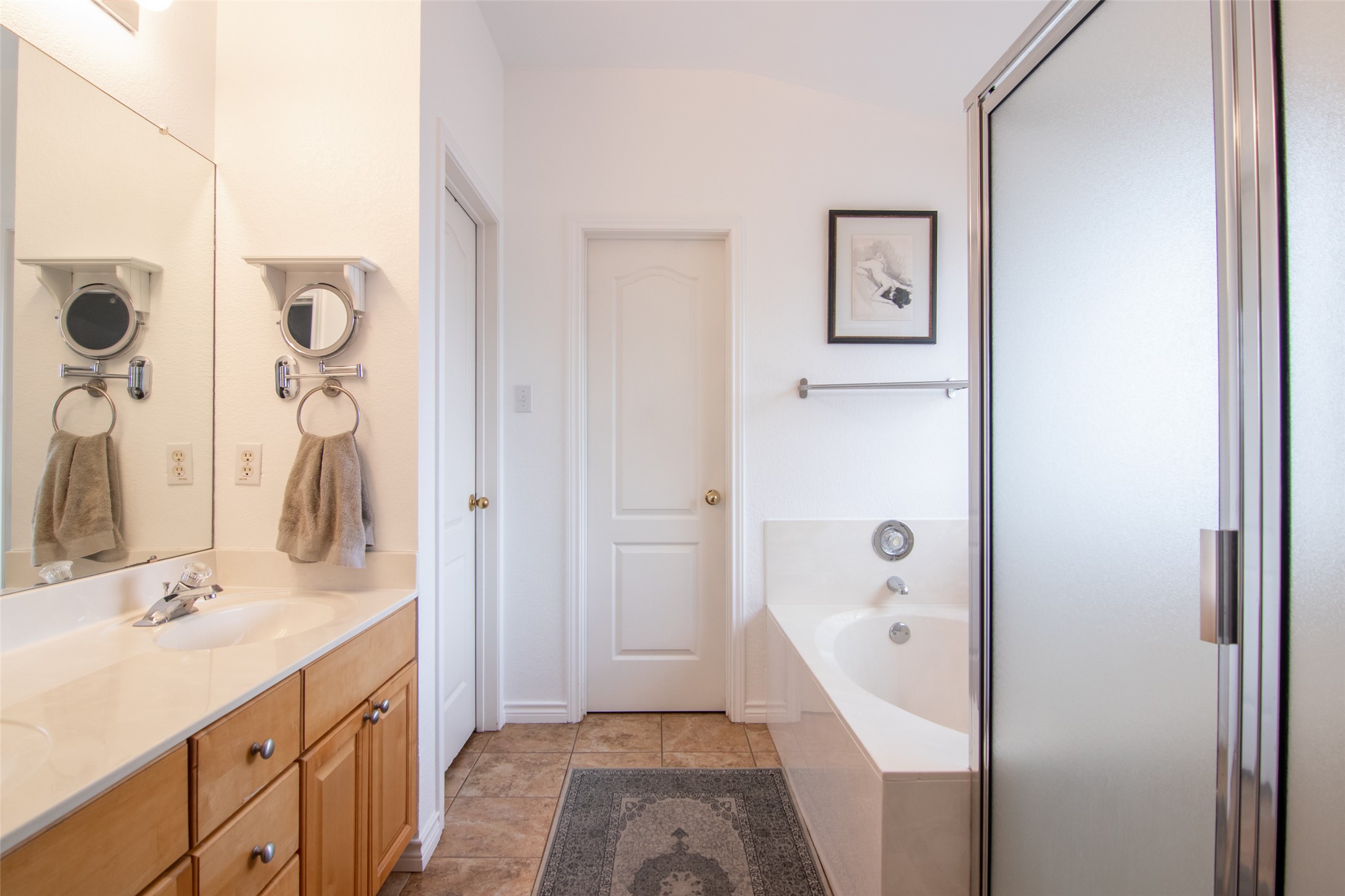 8901 Copano Drive Austin, TX 78749 - Photo 19 of 29 The primary bathroom features a double vanity, separate soaking tub and shower, and a spacious walk-in closet.