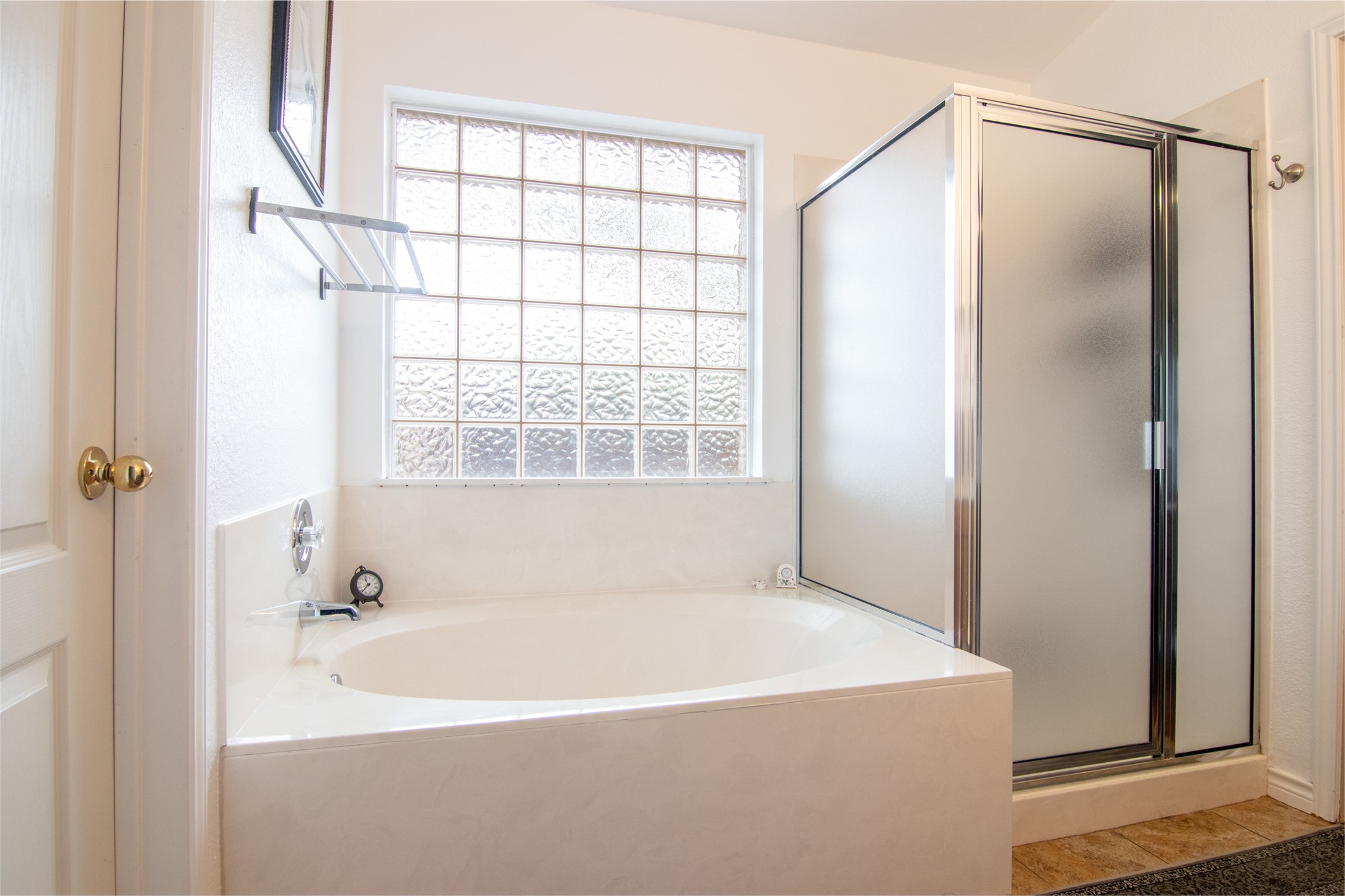 8901 Copano Drive Austin, TX 78749 - Photo 21 of 29 The primary bathroom includes both a separate soaking tub and a walk-in shower.
