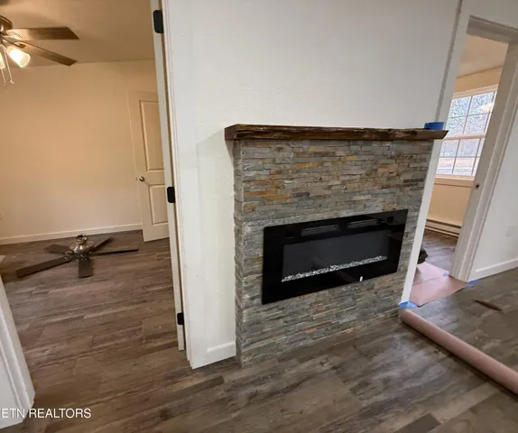 a kitchen with a refrigerator a stove top oven a sink and dishwasher with wooden floor