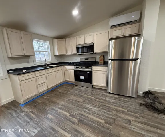 a view of a house with a yard and wooden fence